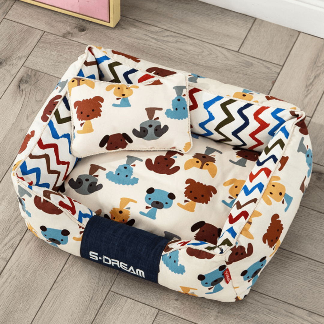 Sofa Dog Bed – Washable, Anti-Chew, Ultra Soft & Detachable bag with colorful dog pattern on a wooden floor