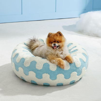 CozyPaw Donut Dog Bed – Modern Design, Soft & Warm, Washable Small dog sitting on a blue and white patterned pet bed.