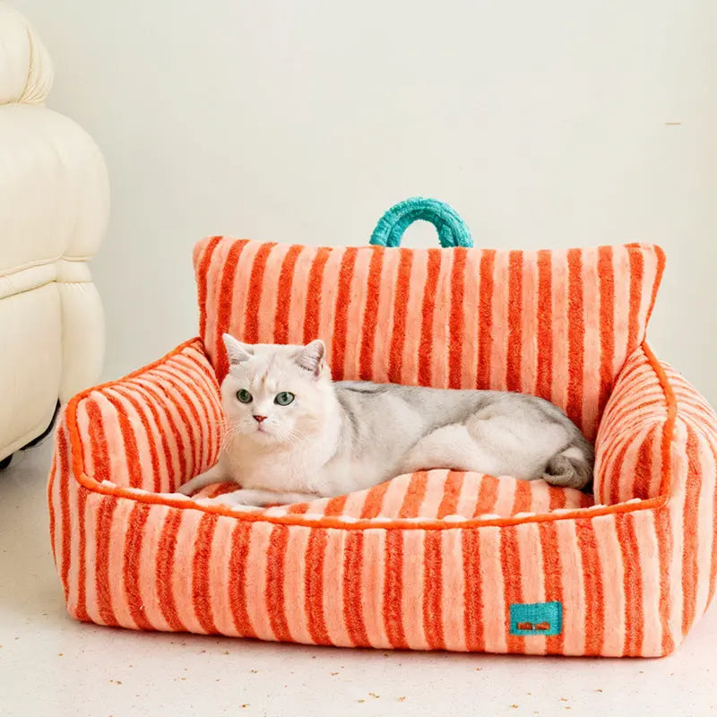 White cat lying on a striped orange and pink pet bed with a blue handle.
JoyPup Universal Sofa-Style Pet Bed – Soft Velvet, Cozy & Detachable,