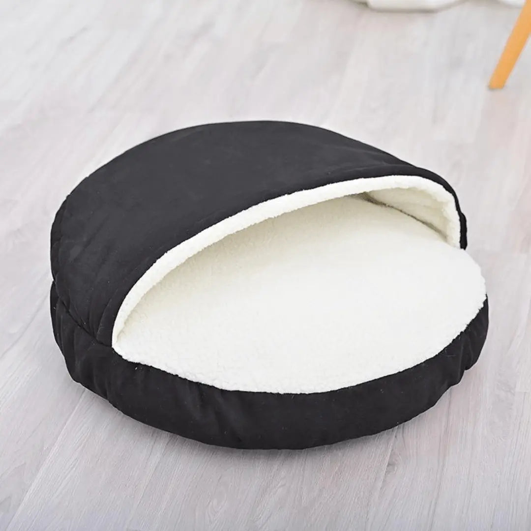 Calming Ultimate Anti-Anxiety Dog Bed – Cozy Hooded BedBlack pet bed with white interior on a light wooden floorJoypup